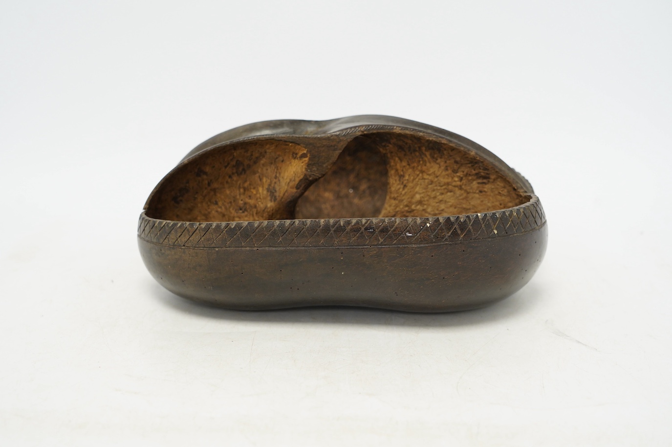 A coco de mer carved dish, 25cm wide, 18cm high. Condition - fair